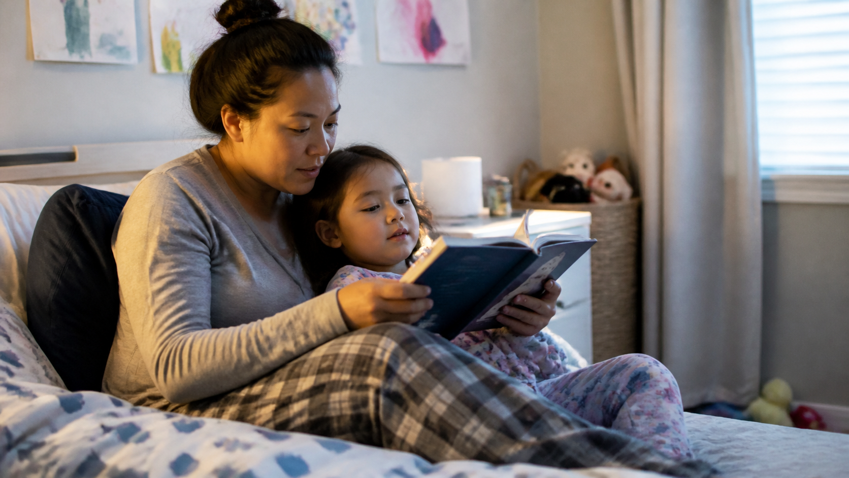 Parent and young child reading a picture book together at bedtime