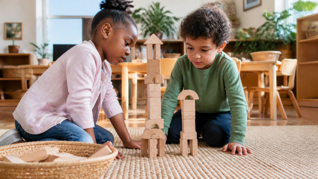 Two preschool children comparing the height of wooden block towers